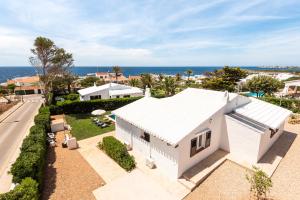 an aerial view of a white house with the ocean in the background at Villa BiniRe in Binibeca