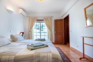 a bedroom with two beds and a window at Villa Goshen in Lagos +26 photos