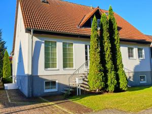 a house with two trees in front of it at Ferienhaus Ruegenliebe 01 in Binz