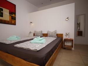 1 dormitorio con 1 cama grande y toallas azules. en S´Hort de Can Carrió en Las Salinas