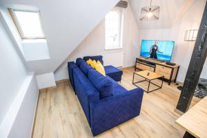 Televízia a/alebo spoločenská miestnosť v ubytovaní Loft 33