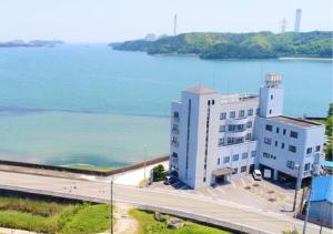a large building next to a large body of water at Bayside Hotel Ryugu / Vacation STAY 63714 in Anan