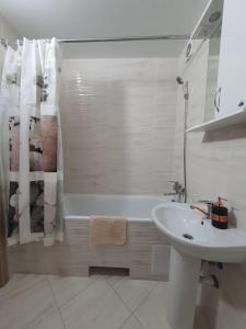 a white bathroom with a sink and a bath tub at Апартаменти Класик у ЖК Яровиця in Luts'k