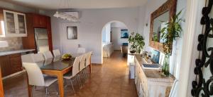 a kitchen and dining room with a table and chairs at Villa Santa Mavra in Glinado Naxos