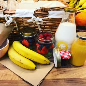 a basket of fruit and a basket of milk at Cornerways in Ventnor