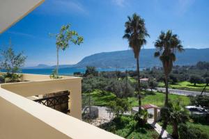 a view from a balcony of a house with palm trees at Sea view Penthhouse in Souda