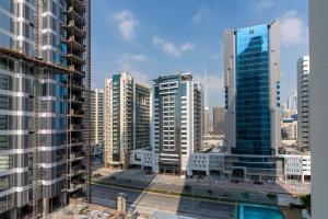 a view of a city with tall buildings at Vacay Lettings - 1BHK convertible to 2BHK in Business Bay in Dubai