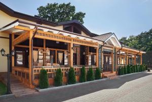 a building with a porch with trees in front of it at Complex Turistic Codru in Selişte