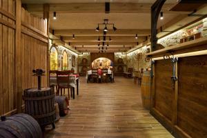 a wine cellar with wooden walls and tables and chairs at Complex Turistic Codru in Selişte