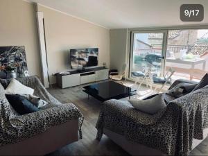 a living room with two couches and a television at COCCO HOUSE in Rocca San Giovanni