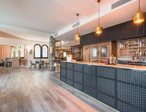 a bar in a restaurant with tables and chairs at Rivalta Life Style Hotel in Salò