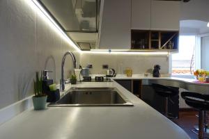 A kitchen or kitchenette at TUSCANY LOFT IN THE CITY