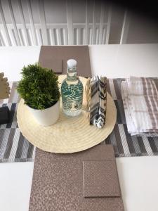 een tafel met een fles en een potplant erop bij Luxurious & Spacious 5 Bedroom Property in Belvedere