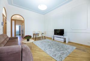 a living room with a couch and a flat screen tv at Квартира в центре Киева in Kyiv
