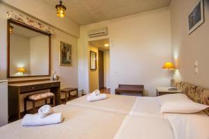 Posteľ alebo postele v izbe v ubytovaní Muses Hotel