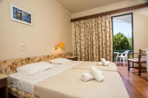 Posteľ alebo postele v izbe v ubytovaní Muses Hotel