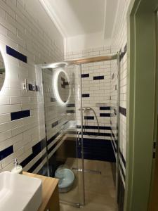 a bathroom with a shower with a toilet and a sink at Apartament Poezja Ciszy in Dębki