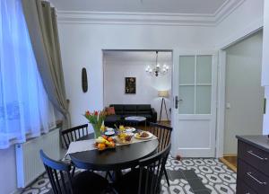 a kitchen and living room with a table and chairs at Rzeszowska 5 Apt. 3 in Krakow
