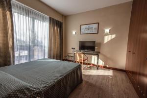 Postel nebo postele na pokoji v ubytování Hotel Petra