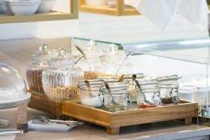 a counter with jars of food and other food items at Rivalta Life Style Hotel in Salò