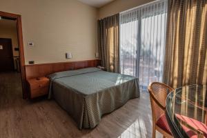Postel nebo postele na pokoji v ubytování Hotel Petra