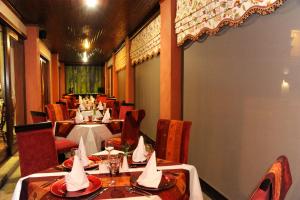 a restaurant with tables and chairs with hats on them at Anta Boga Hotel in Bloemfontein