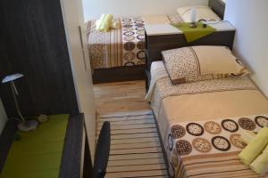 a small room with two beds and a desk at Kalelarga 4 You Apartments in Zadar