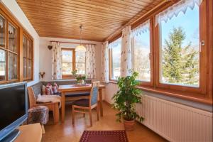シェーナウ・アム・ケーニッヒスゼーにあるFerienwohnung Grünsteineckのテーブルと椅子と窓のある部屋
