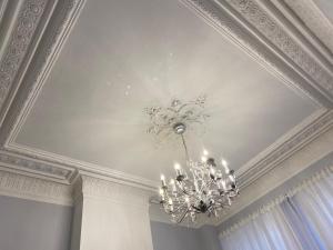 a ceiling with a chandelier in a room at CoCo Romantic - apartment in most trendy central hotspot of Antwerp in Antwerp