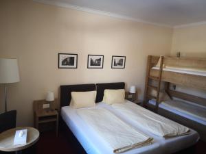 a bedroom with a bed and a bunk bed at Hotel Staubbach in Lauterbrunnen