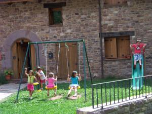 a group of children playing on a swing at Apartamentos Chuandervera in Laspaúles +39 photos