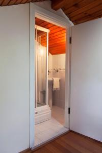 a bathroom with a walk in shower and a tub at Orhan Kutbayin Evi in Buyukada