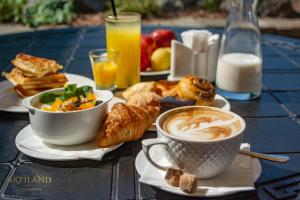 a table topped with two cups of coffee and pastries at ArtiLand in Balashikha