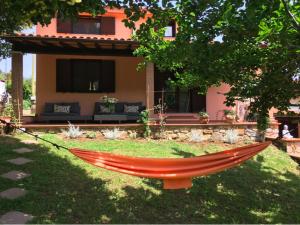 a red hammock in front of a house at Villa Shanti Yoga & Meditation in Marciana