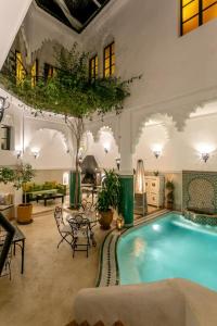 a large room with a large swimming pool at Riad Hart Essoura in Marrakech