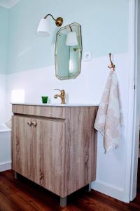 a bathroom vanity with a mirror and a sink at Casa de Vila Seca in Peso da Régua