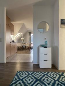 a kitchen and a living room with a table at Antonia Strandstr 21 Whg 6 in Zingst
