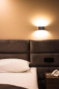 Ένα ή περισσότερα κρεβάτια σε δωμάτιο στο NEW Garni Hotel FILIA