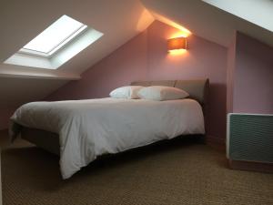 a bedroom with a large bed with a window at GITE MAISON WEEK END in Dunkerque
