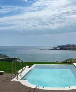 a swimming pool with a view of the ocean at Cabo Villas in Arapya