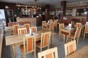 a dining room with wooden tables and chairs at Penzion Jízdárna Suchá in Litomyšl
