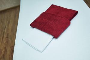 a red napkin sitting on top of a white paper at Mini Otel Spokoyny Otdyh in Stavropol