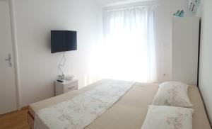 Postel nebo postele na pokoji v ubytování Apartments Oliva