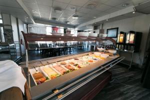 a display case in a restaurant filled with food at Hamar Vandrerhjem in Hamar