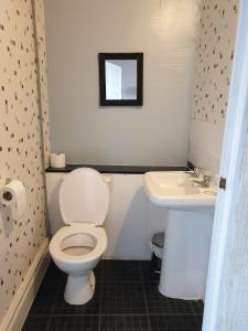 a bathroom with a toilet and a sink at Foxhall Village Guest House in Blackpool