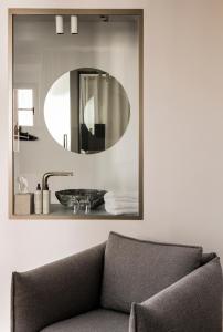a bathroom with a sink and a mirror on the wall at Kai 36 - Hotel zwischen Fels und Fluss in Graz