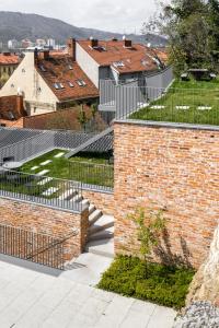 an external view of a building with a metal fence at Kai 36 - Hotel zwischen Fels und Fluss in Graz