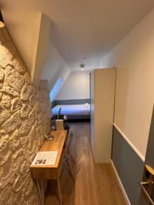 A bed or beds in a room at Hôtel Tilde