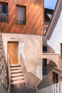 two views of a house with stairs and a door at Kai 36 - Hotel zwischen Fels und Fluss in Graz