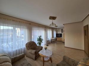 a living room with a couch and a table at Hotel Mimoza in Libusza